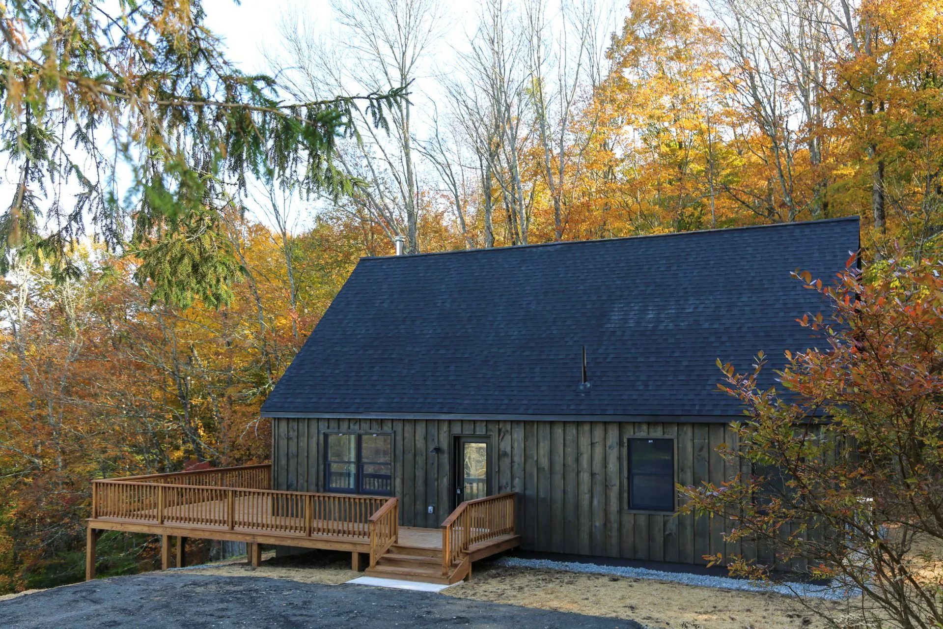 Restored log home surrounded by autumn woods in Eagle River, Wisconsin