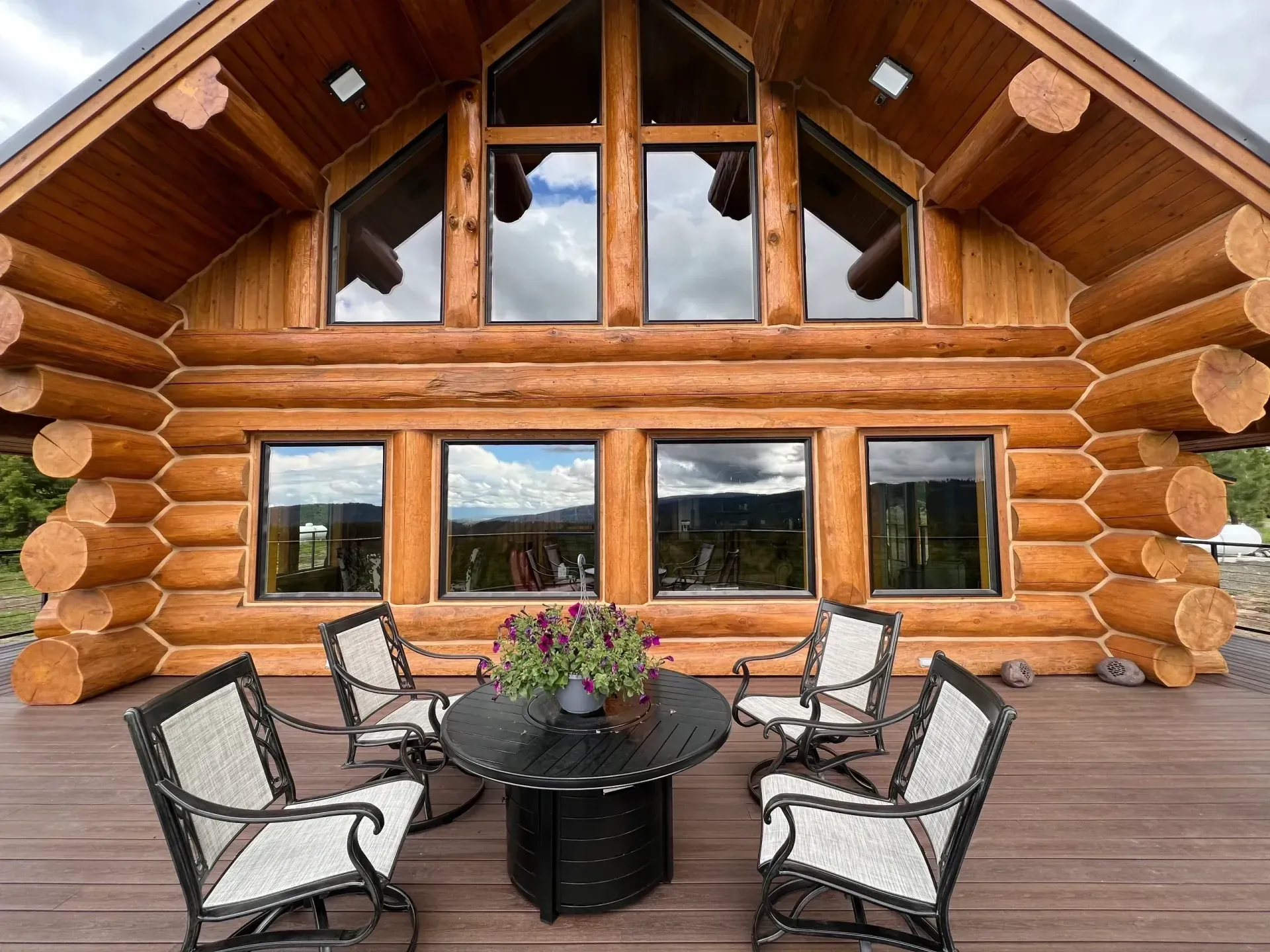 Log home deck with freshly caulked windows