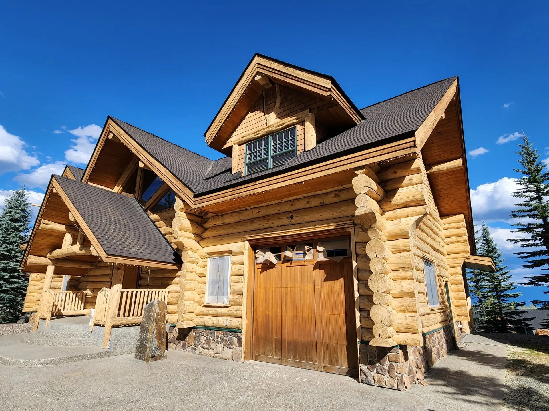 Grand log home with fresh finish and stonework