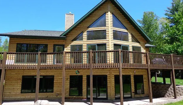 Restored two-story log home with new deck and windows